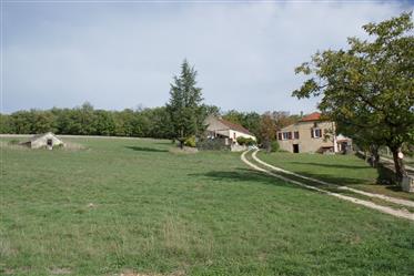 Property on 7.32 ha in one piece with restored house, outbuildings, source. Panoramic view.