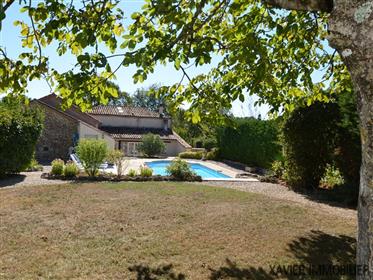 Stone country property with pool and attached barn on a plot...