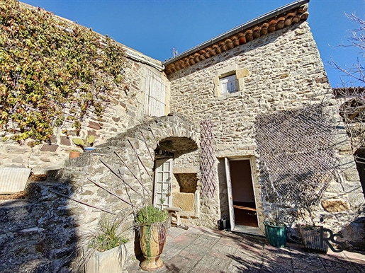 Located in a typical hamlet, a charming renovated stone house with about 101m2 living area