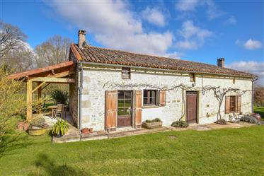 Pretty detached stone house set in its own gardens, with land and barn.